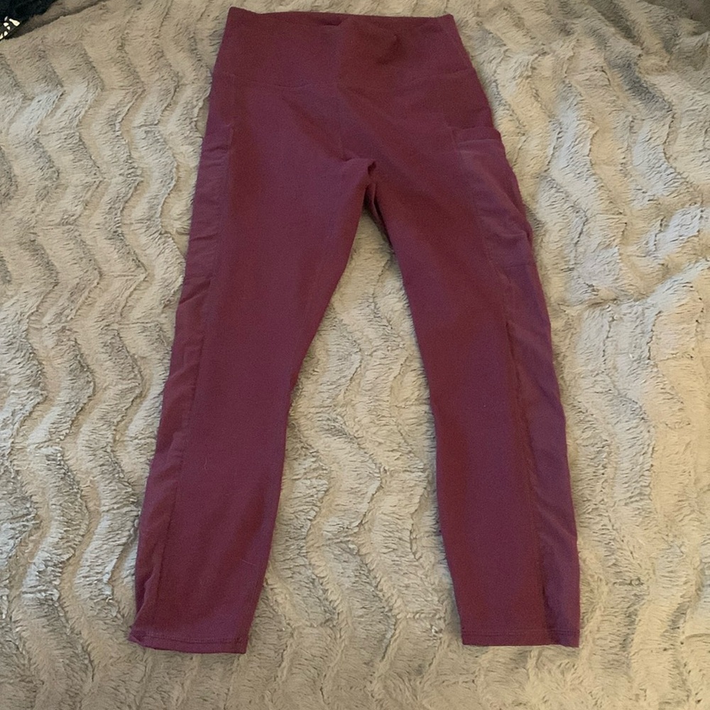 Maroon Fabletics 3/4 leggings with mesh accent and phone pocket